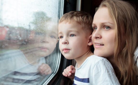 mother-and-son-looking-through-a-train-window